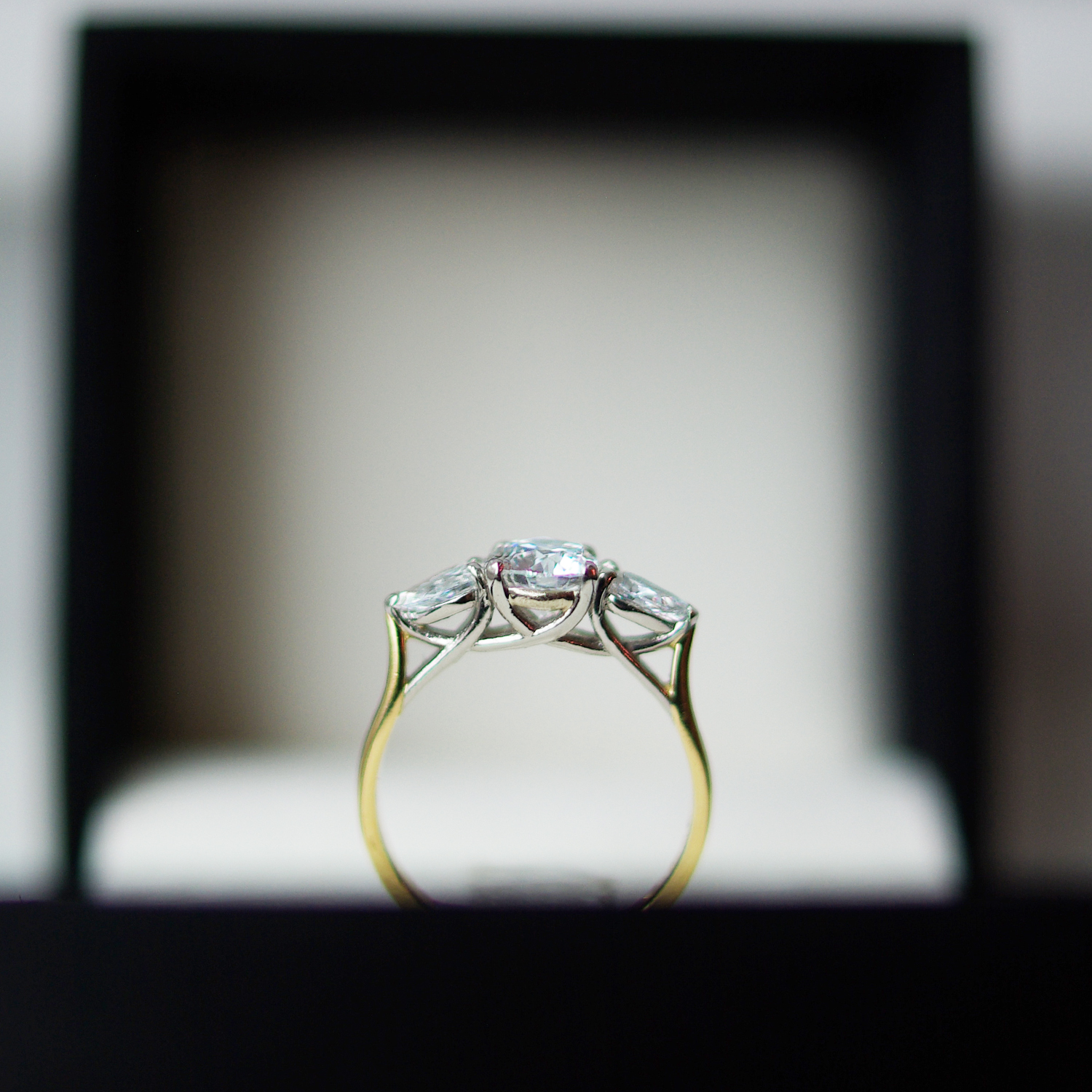 Trilogy Engagement Ring With a Round Brilliant Cut Diamond And Pear Cut Diamond Outers
