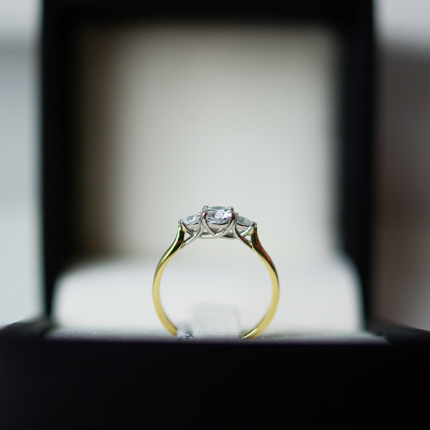 Trilogy Engagement Ring With a Round Brilliant Cut Diamond And Pear Cut Diamond Outers