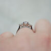 Trilogy Engagement Ring With a Round Brilliant Cut Diamond With Pear Cut Diamond Outers