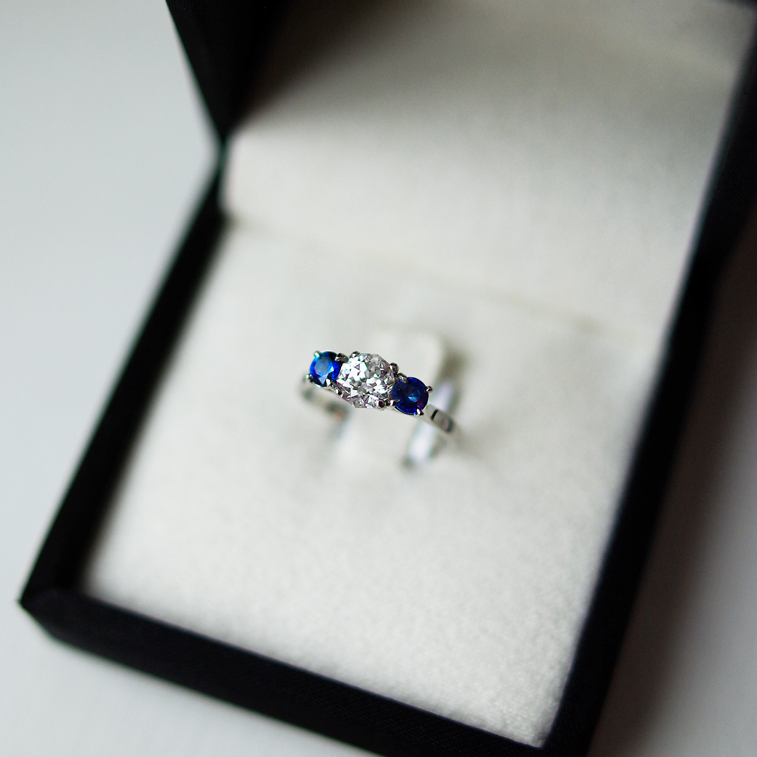 Trilogy Engagement Ring With Two Round Brilliant Cut Sapphires And a Meteor Cut Diamond