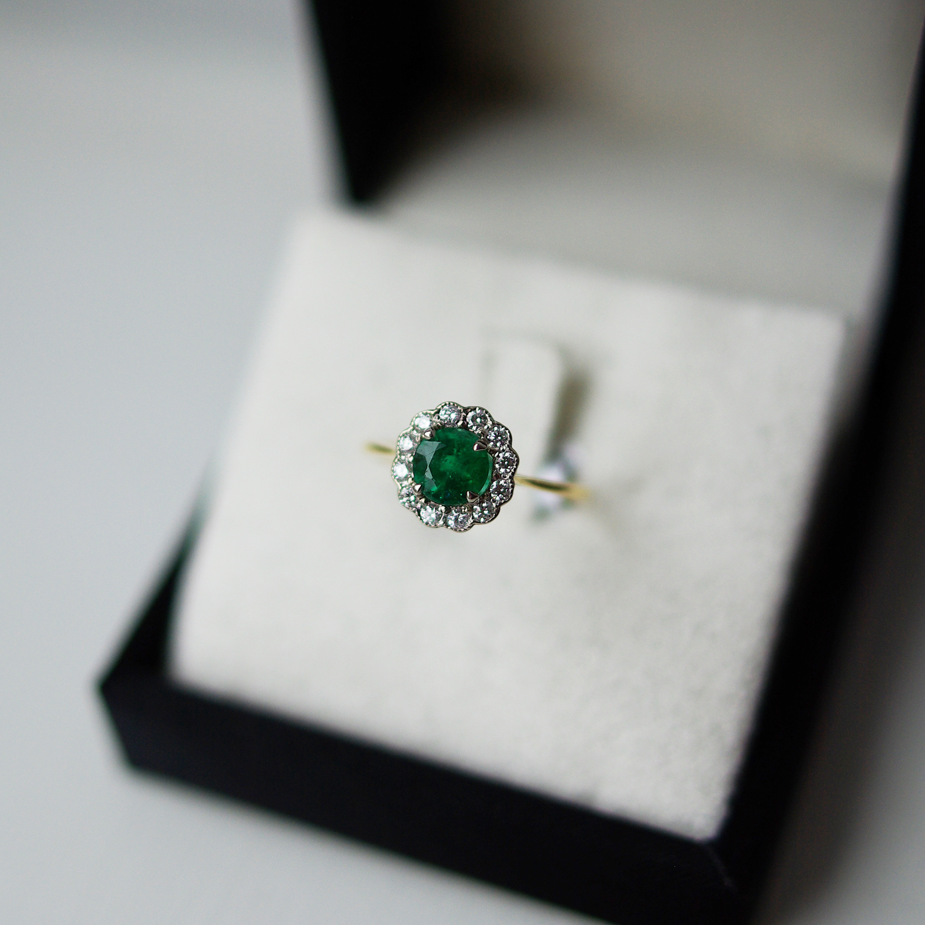Round Brilliant Cut Emerald With a Diamond Halo Ring