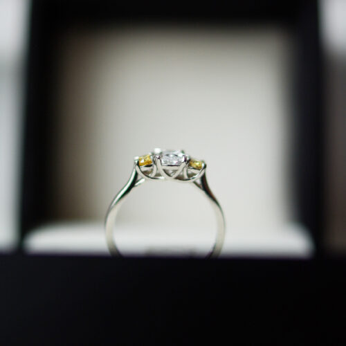 Trilogy Engagement Ring With Two Round Brilliant Cut Yellow Diamonds And A Colourless Oval Cut Diamond